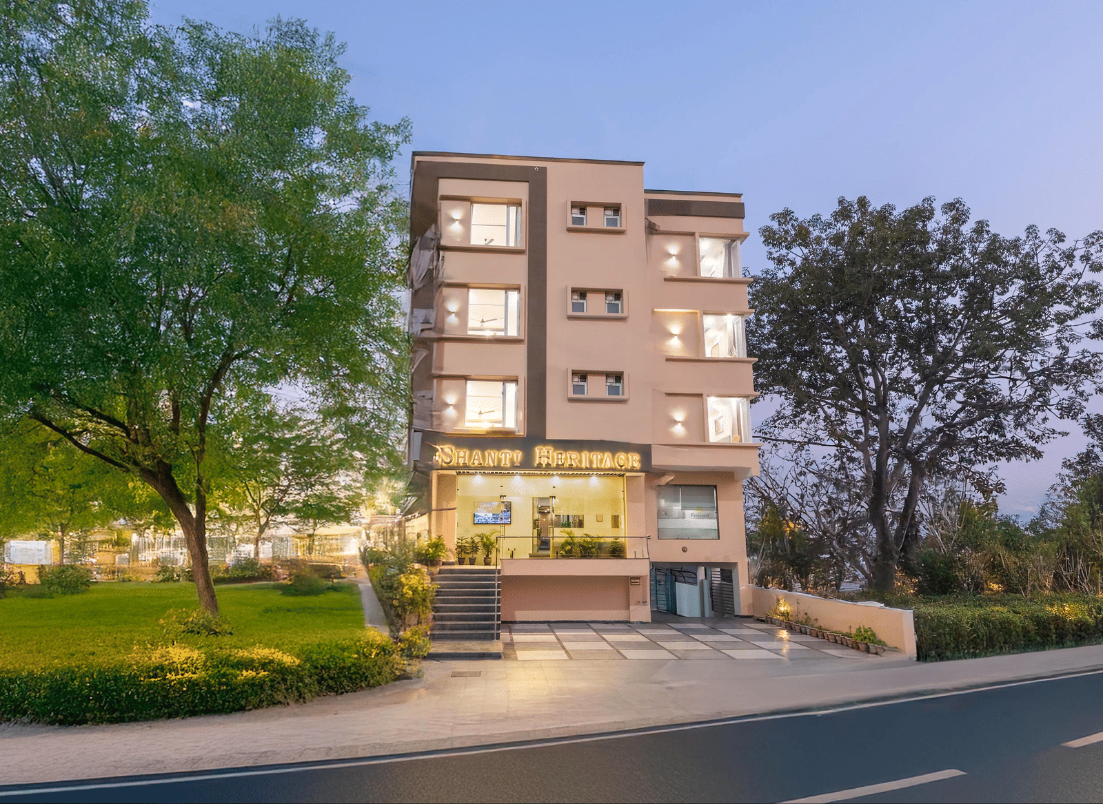 Facade of Perfectstayz Premium Shanti Heritage, Haridwar with trees surrounding the hotel.