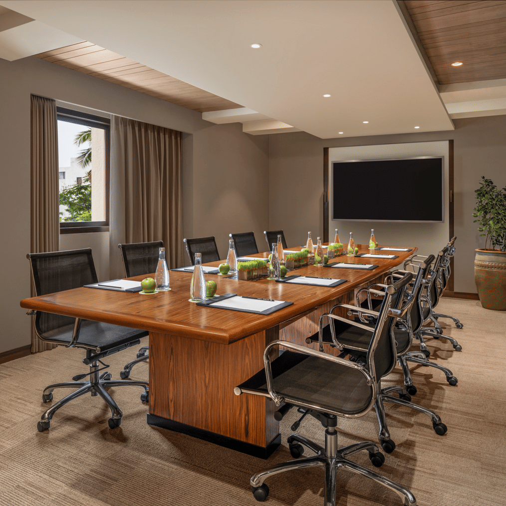 Meeting room with long table, chairs, and a presentation screen at The Raintree, St. Mary’s Road.