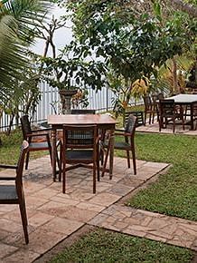 An open-air dining seating at Manger Cafe at Samiira on Ashtamudi Lake.