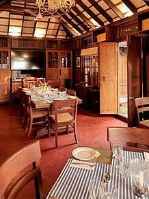 An indoor dining seating at Manger Cafe at Samiira on Ashtamudi Lake.