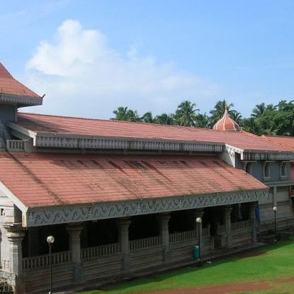 facade view of Shri Mahalsa Temple Mardol with blue sky in the background