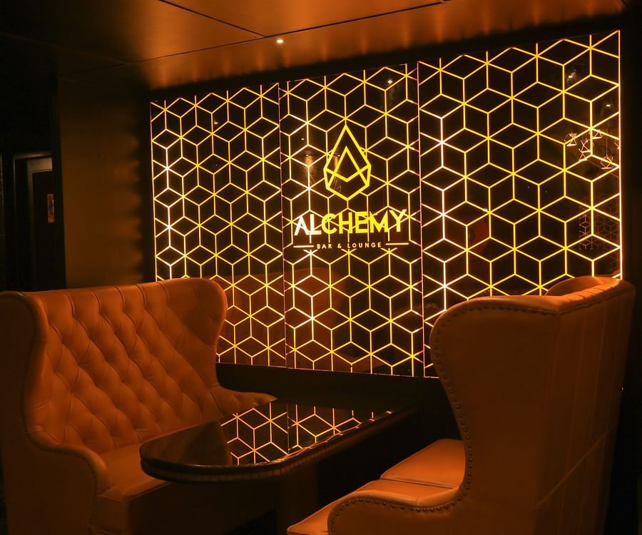 single seater sofas inside the Lounge at Alchemy, our in-house bar in Chennai - Raj Park Hotel, Chennai