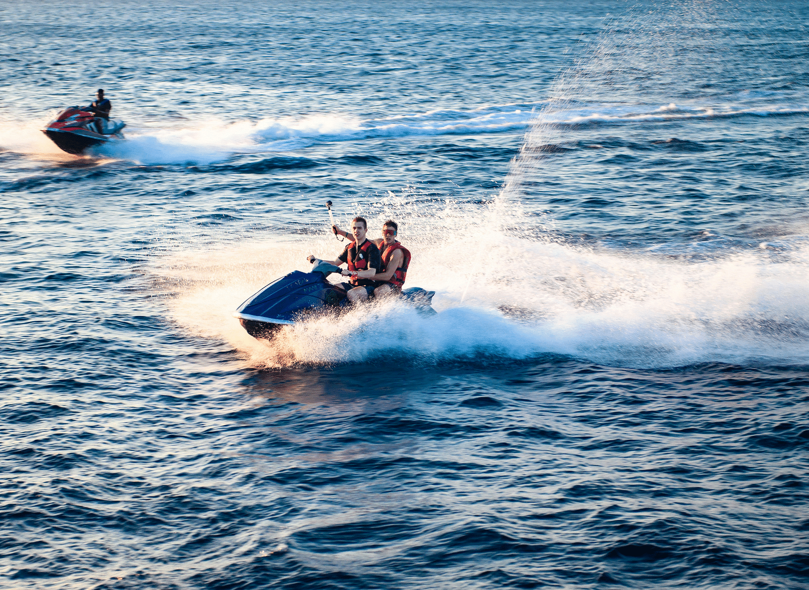 Image of people riding a jet boat on a waterbody.