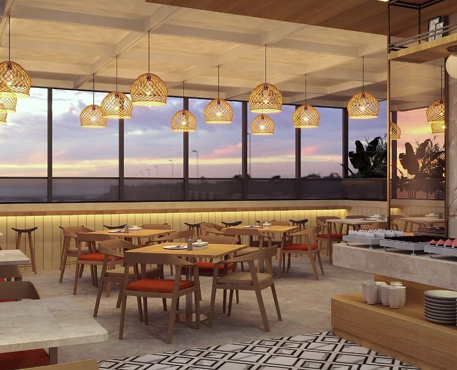 Seating area with modern lights above inside the restaurant - TGI Livancia The Sojourn, Bangalore