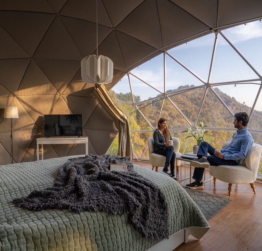 An image of couple having a chat in a room at avalon cottages view a serene view