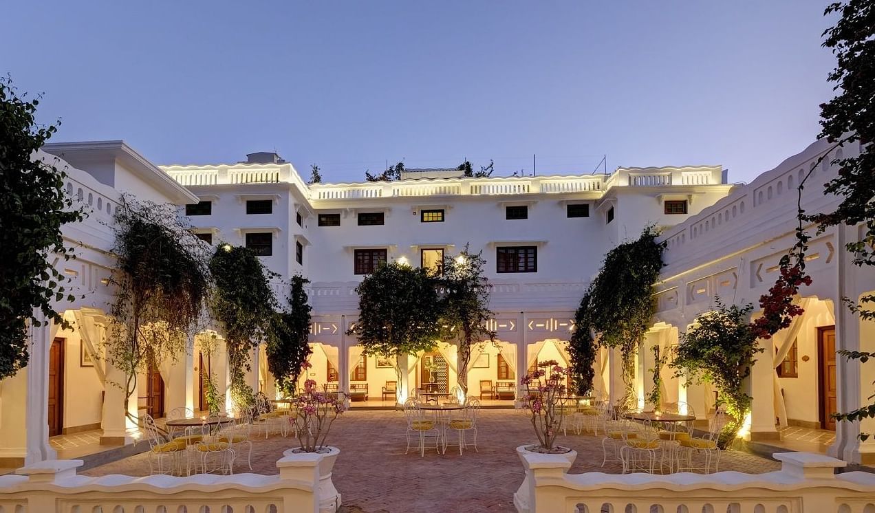 A wide view of the central courtyard at Saraca Hotel, Lucknow during blue hour