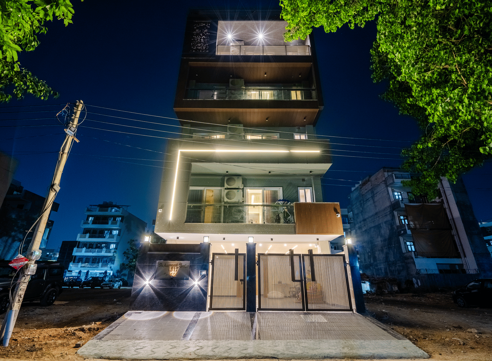 Night view of the multi-storey serviced apartment building with bright lighting at Lime Tree 1BHK Service Apartment Near Artemis Hospital Gurgaon.