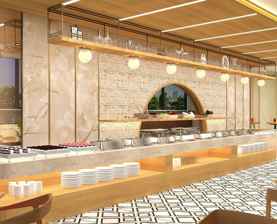 The buffet area in view with cutlery and lights above it - TGI Livancia The Sojourn, Bangalore