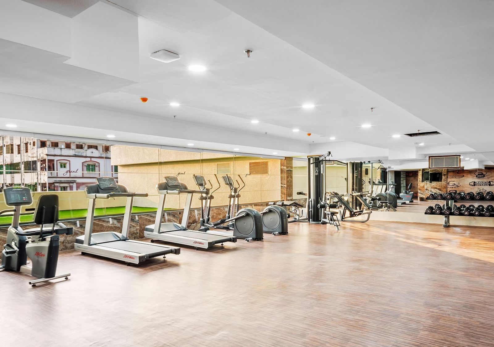 A view of the fitness centre with treading mills placed next to each other at Grand Vijayawada by GRT Hotels.