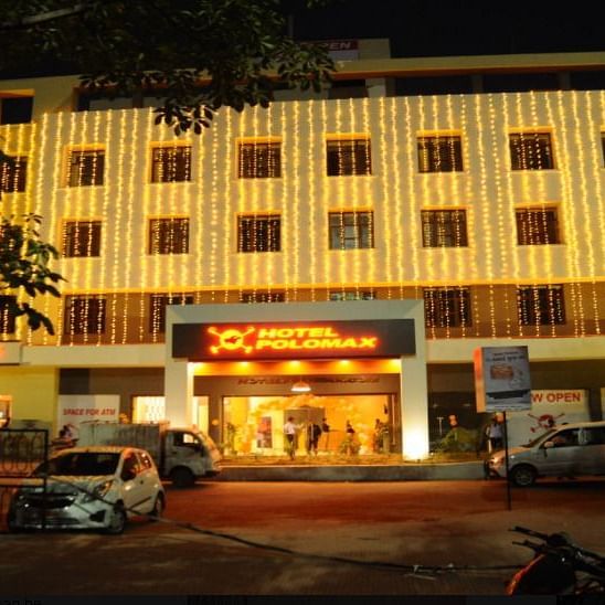alt-text Hotel Polo Max at night illuminated with string lights on the facade.