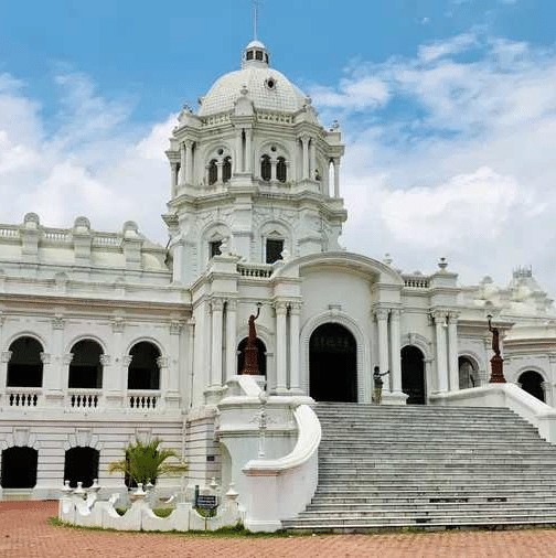 A wide shot of two-story white Ujjayanta Palace in Agartala.