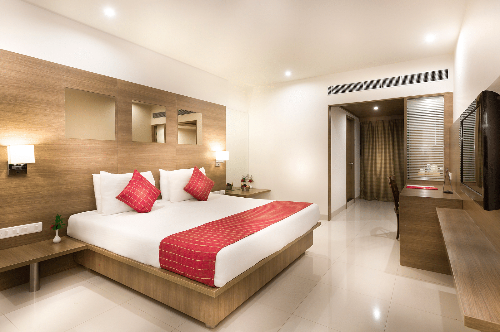 An image of a king size bed of a Deluxe Room at Regency Tiruttani by GRT Hotels.