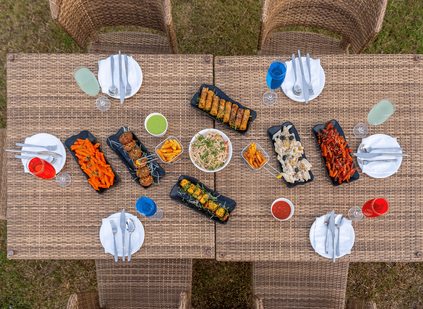 Outdoor dining setup with neatly arranged food and cutlery at DLS Park Grace, Haridwar.