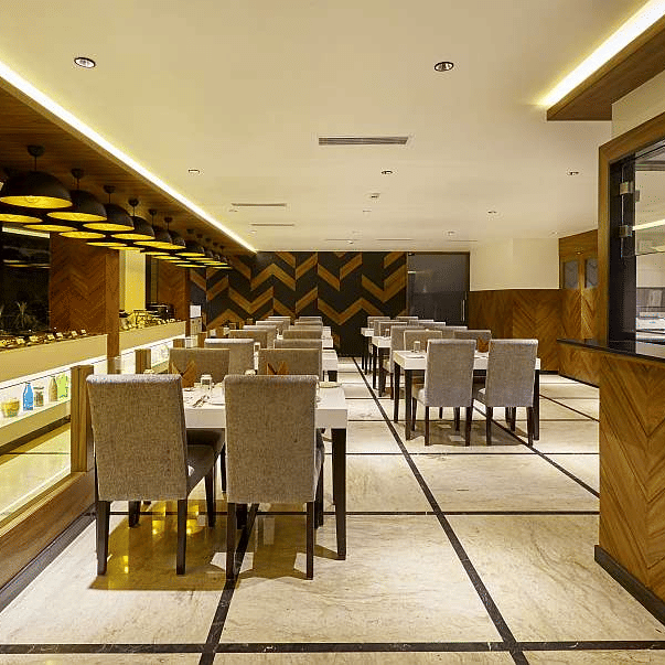 A well-lit restaurant interior with neatly arranged tables and chairs, showing a modern dining space at The Citrine.