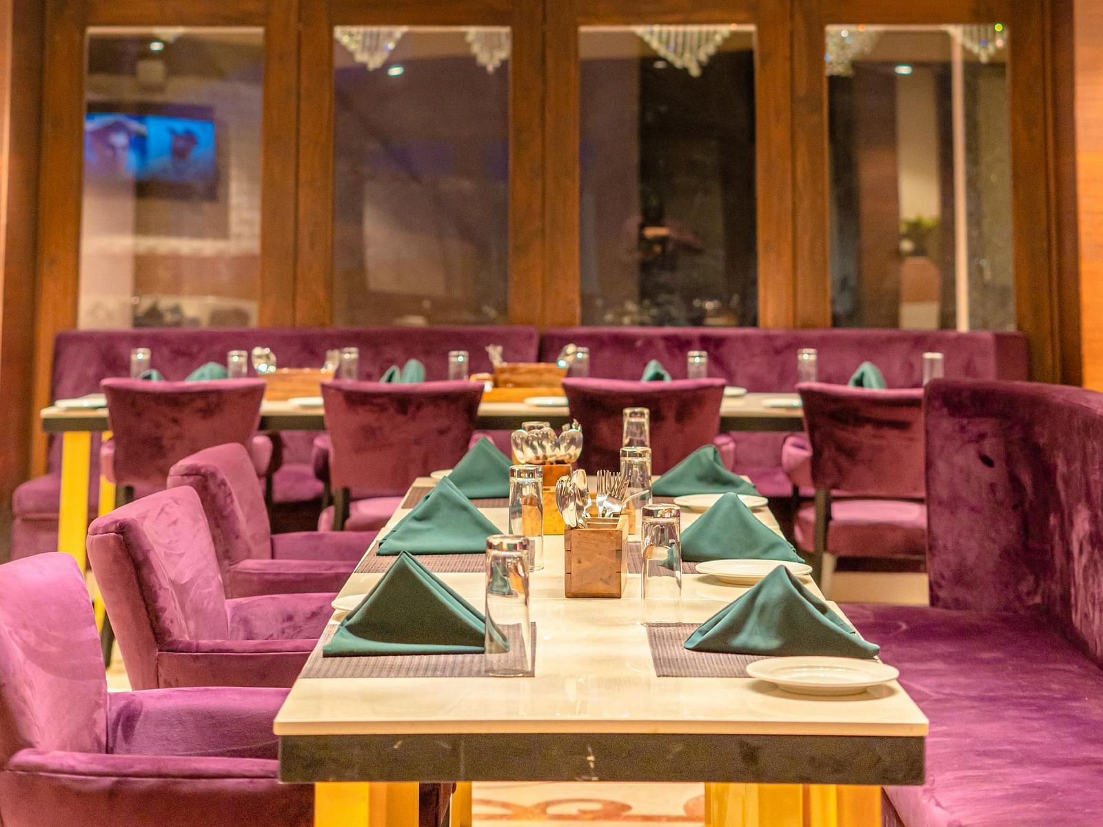 Guests at Courtyard Fine Dine, Crescent Spa & Resort, Indore, are welcomed with cushioned seating and a table elegantly arranged with a variety of culinary treats