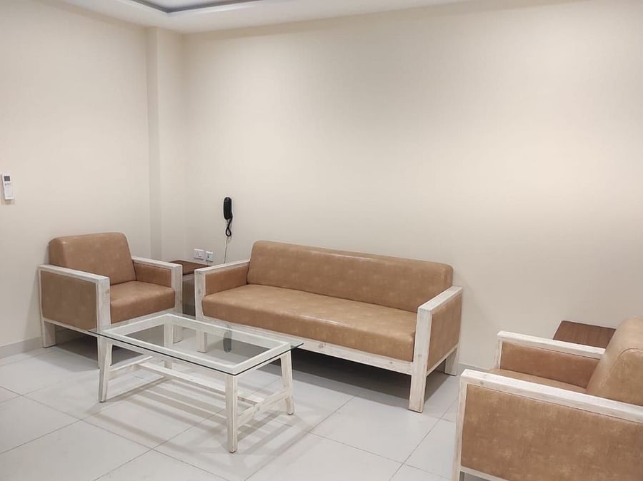A living room with sofas and a table - A M Suites