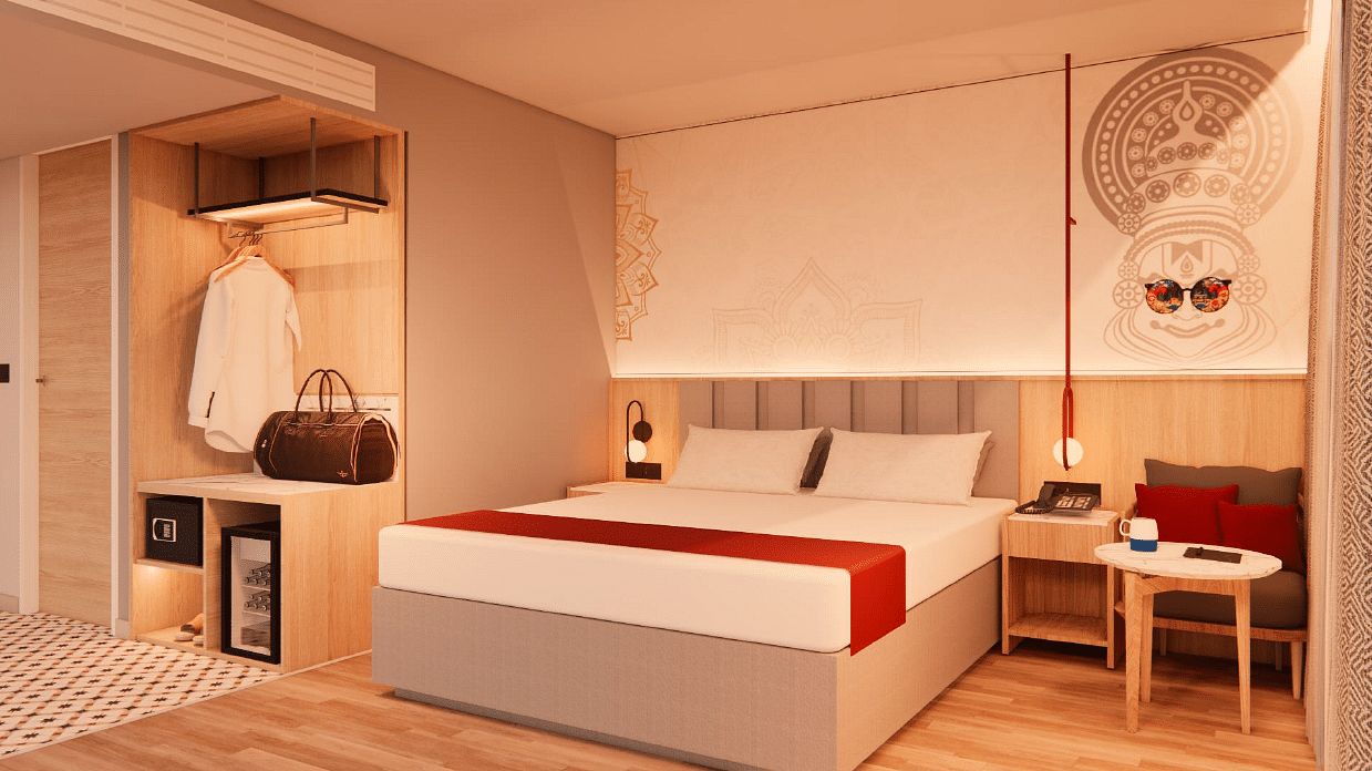 A spacious room with warm lighting, a bed, bedside tables, a couch, and a coffee table - TGI Oberon, Koramangala