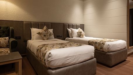Twin beds inside the deluxe room - The Cindrella Hotel, Siliguri