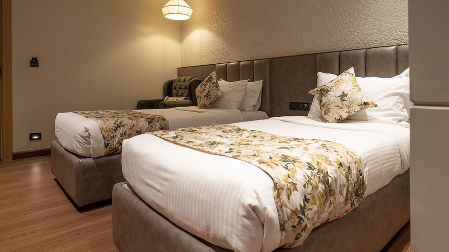 A close up shot of the twin beds inside the deluxe room - The Cindrella Hotel, Siliguri