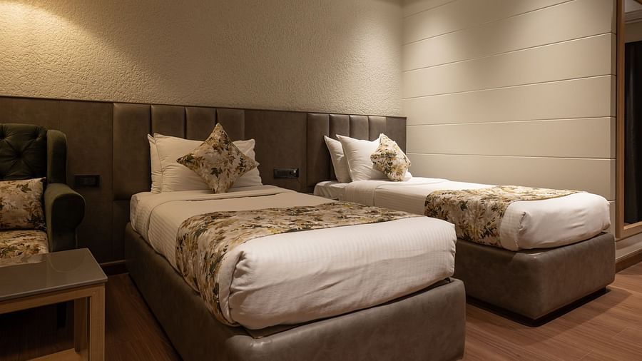 Twin beds inside the deluxe room - The Cindrella Hotel, Siliguri
