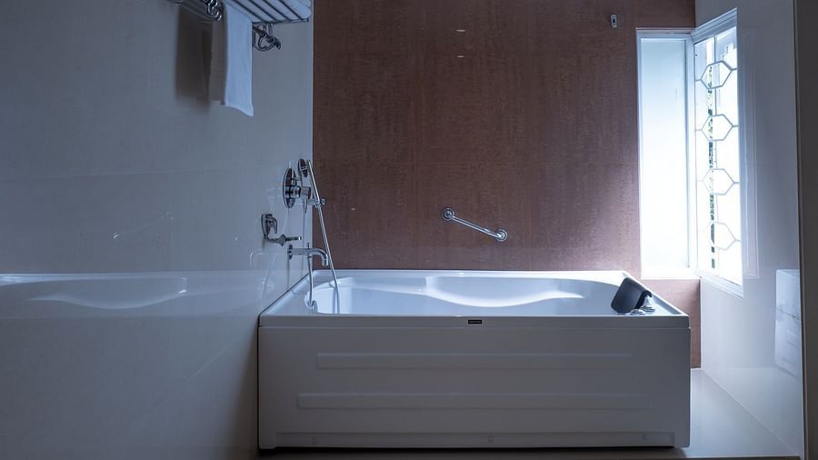 a bathtub inside the bathroom of the suite - The Cindrella Hotel, Siliguri