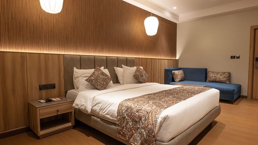 side view of the double bed inside super deluxe room - The Cindrella Hotel, Siliguri