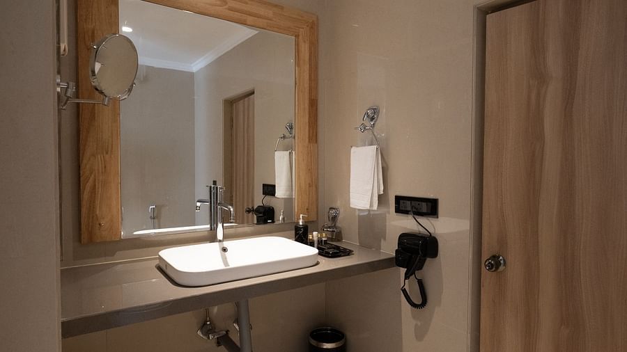 sink area in view with the mirror inside the bathroom of the suite - The Cindrella Hotel, Siliguri