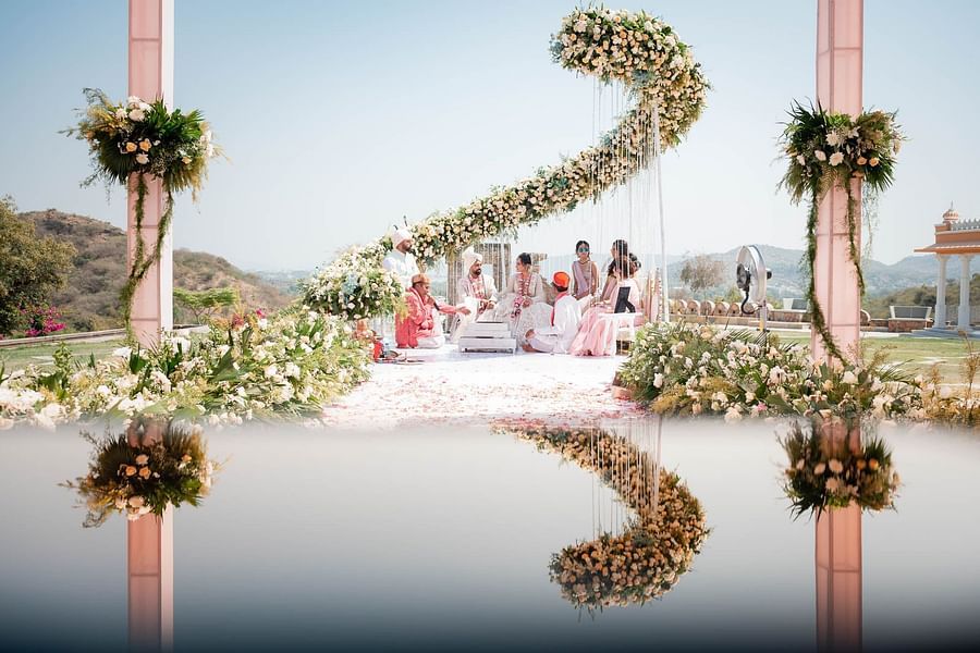 Elegant Hindu wedding ceremony with a stunning floral backdrop and a reflecting pool at Fateh Vilas Collection Udaipur