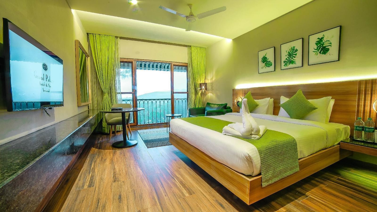 Double bed and balcony in the Deluxe Room at Grand Palace, Yercaud