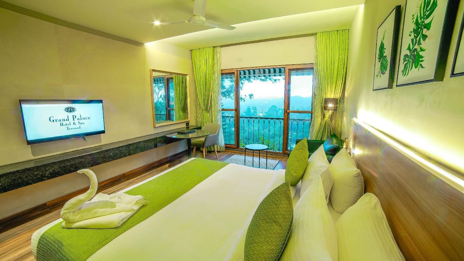 Another angle of the bed and a TV in the Deluxe Room at Grand Palace, Yercaud