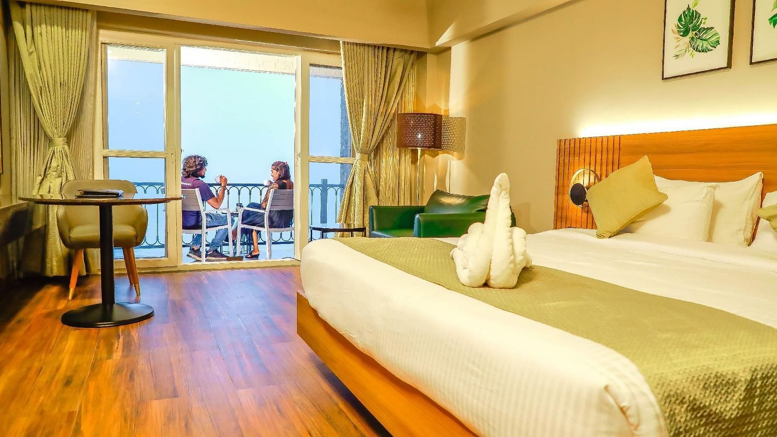 Double bed and balcony of the Superior Balcony Room at Grand Palace, Yercaud