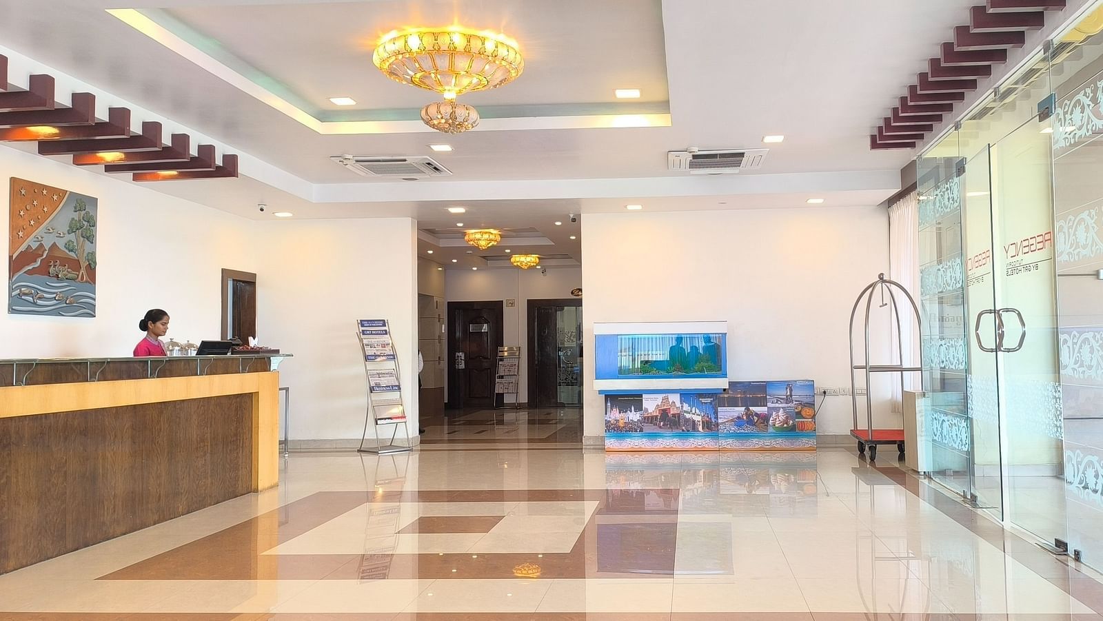 An image of our lobby showcasing a large glass door on the right for guests to enter, and a receptionist standing behind a desk on the left - Regency Tuticorin by GRT Hotels, Best hotel in Thoothukudi