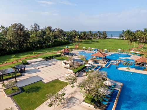An aerial exterior shot of Kenilworth Resort & Spa, Goa featuring a vast swimming pool