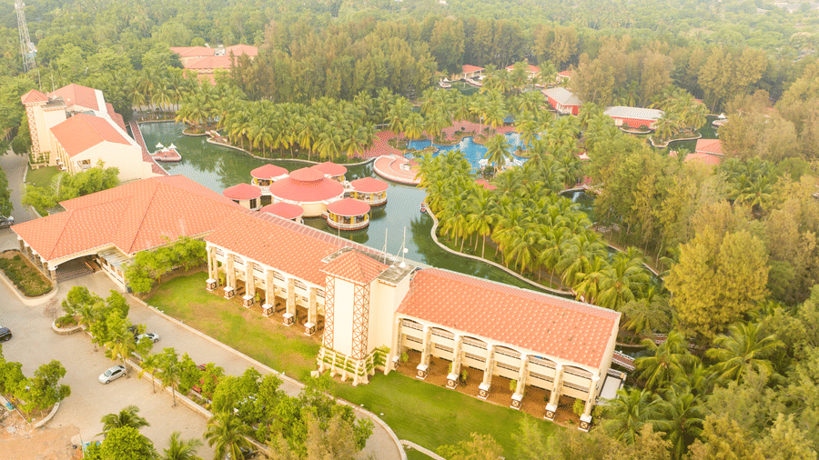 Aerial resort view of Ocean Spray, Puducherry covered by trees and greenery.