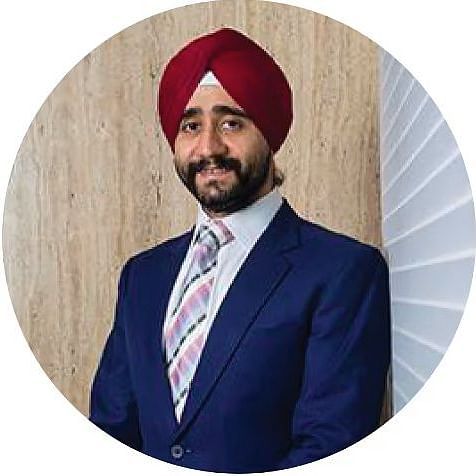Bawa Group of Hotels Vikram Bawa in a suit and turban, standing in a modern office environment