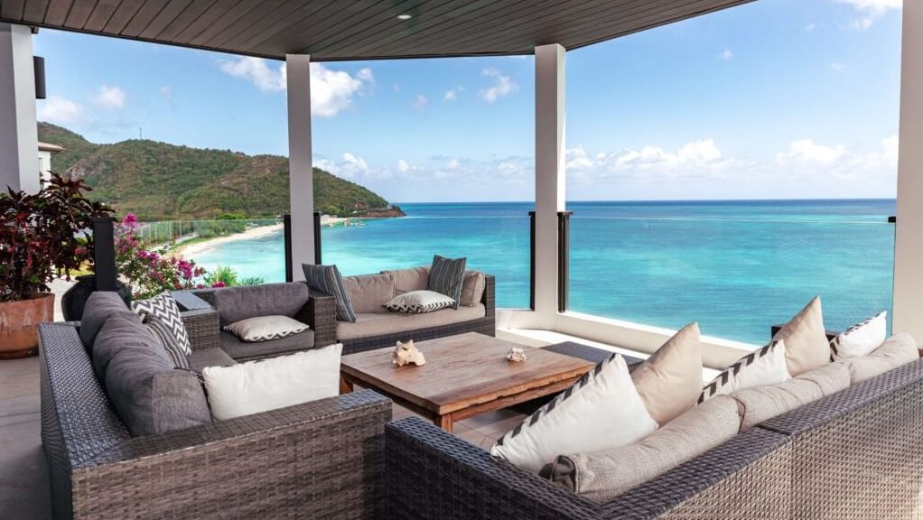 The Ocean View Suite has a comfortable lounge furnished with sofas, a centre table facing the blue expanse of the Caribbean Sea. -Tamarind Hills Resorts & Villas, Antigua