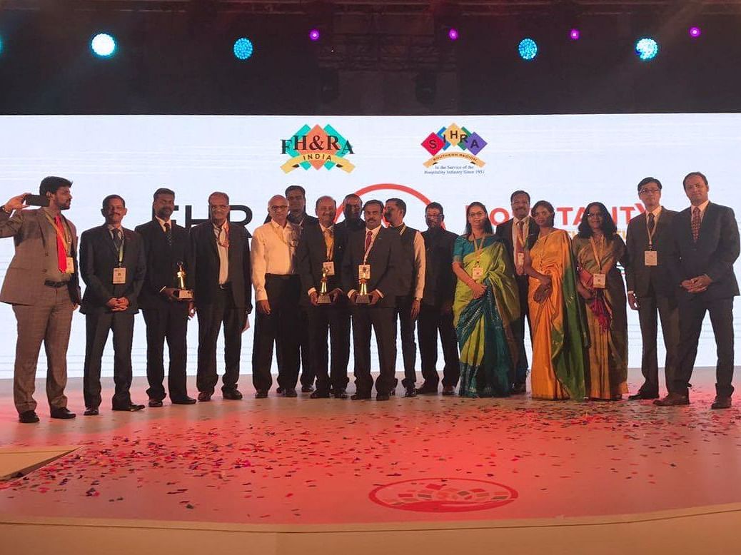 The team posing for a photo after receiving awards at FHRAI1