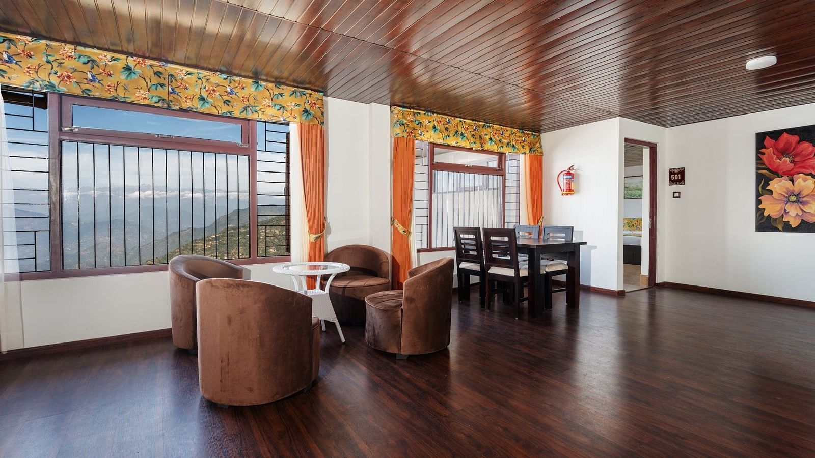 Image of a seating area with chairs and tables at Summit Sherpa Mountain Hotel & Spa, Kalimpong