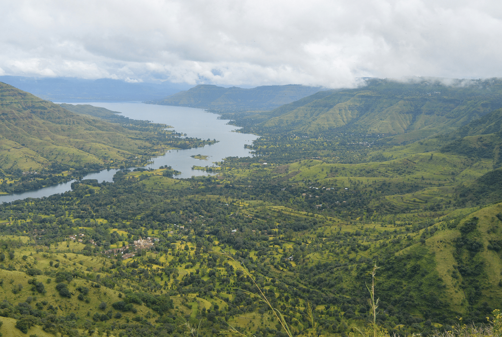 a view of lonavala from above with a valley in view and a river flowing through the mountains