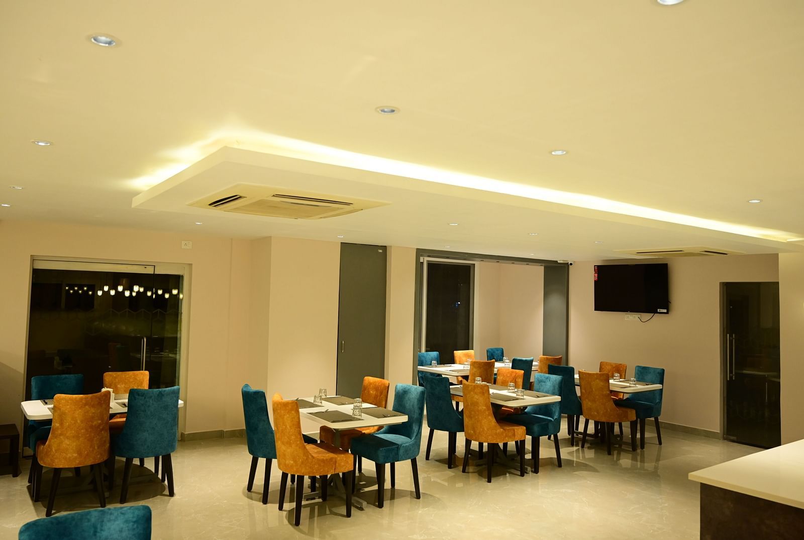 Blue and Yellow coloured chairs at the restaurant at Sterling Keys by TGI in Bnagalore
