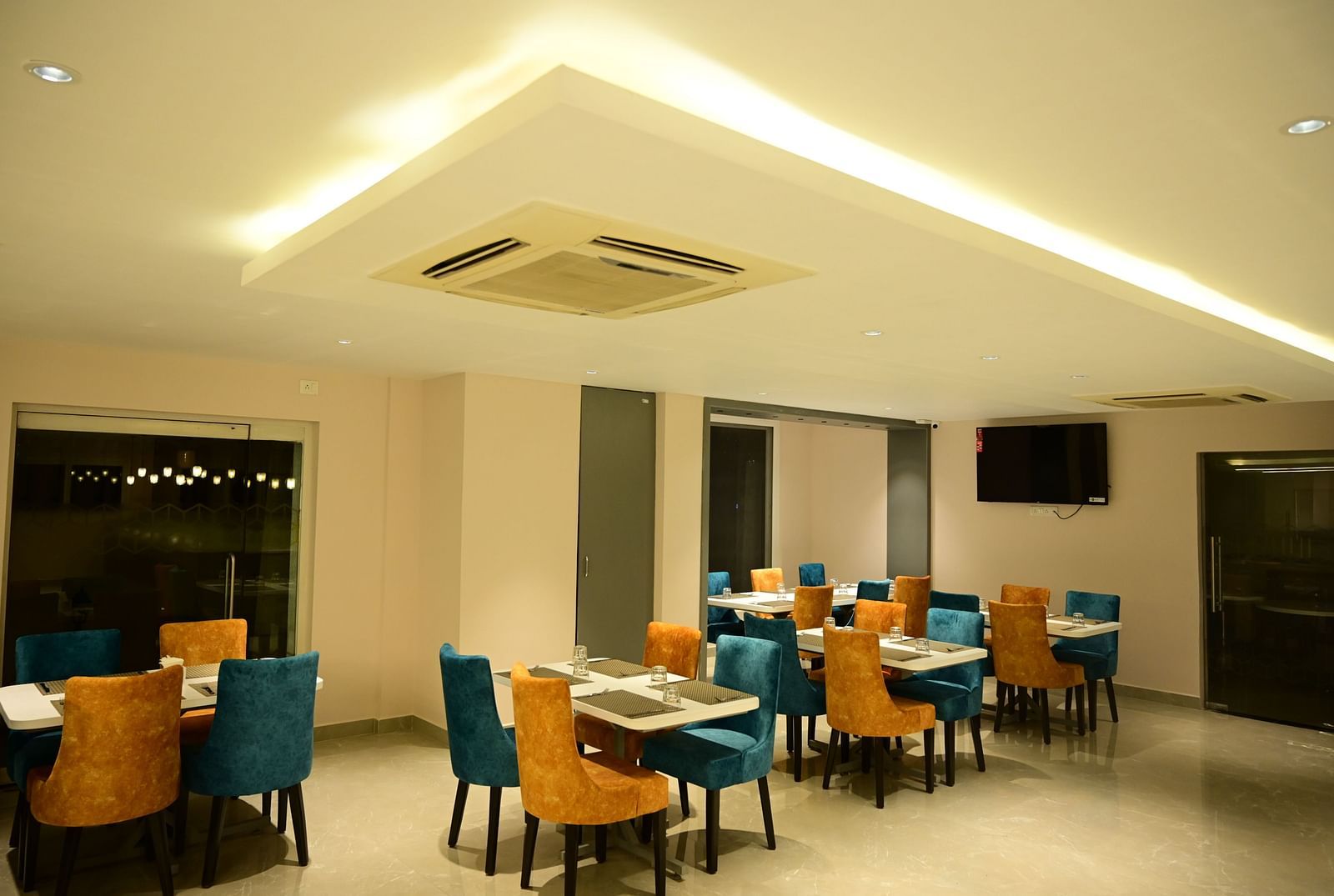 Blue and Yellow coloured chairs at the restaurant at Sterling Keys by TGI in Bnagalore