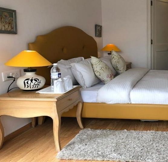 Standard Room with comfy bed and bed table at Pinewood, Nainital