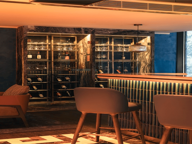 Stylish bar interior with warm lighting and seating at The Residency Towers Chennai.