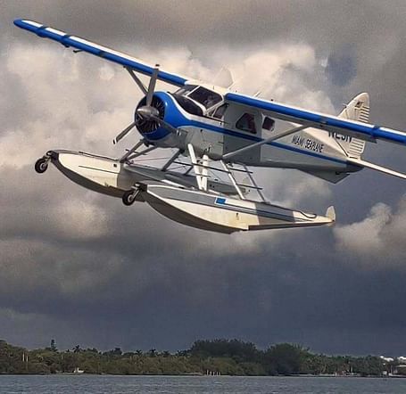 Seaplane flying over the water toward Casa Morada.