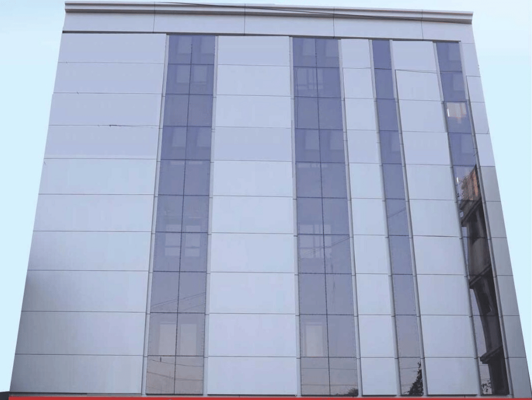 Lords Studio Inn, Jamnagar facade with clouded sky in the background