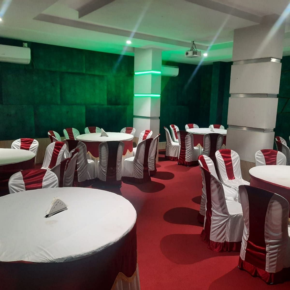A banquet hall featuring well decorated seating arrangements - Mysore Gate Hotel Bangalore