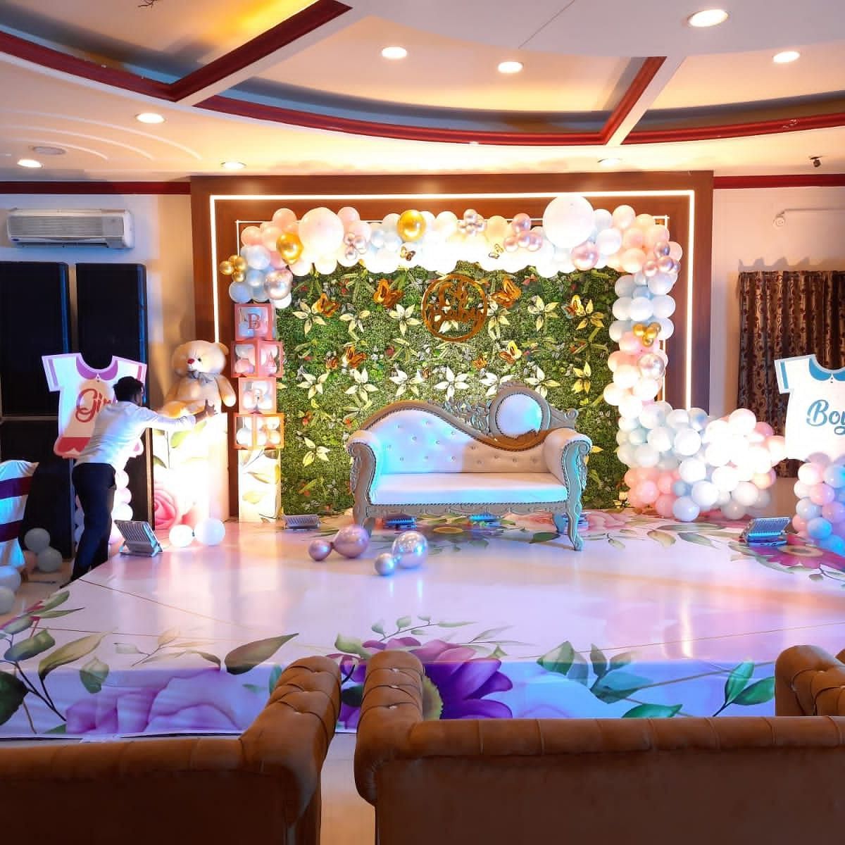 A event hall in Roorkee decorated for a celebration with balloons and a sofa - Motel Divine International, Roorkee
