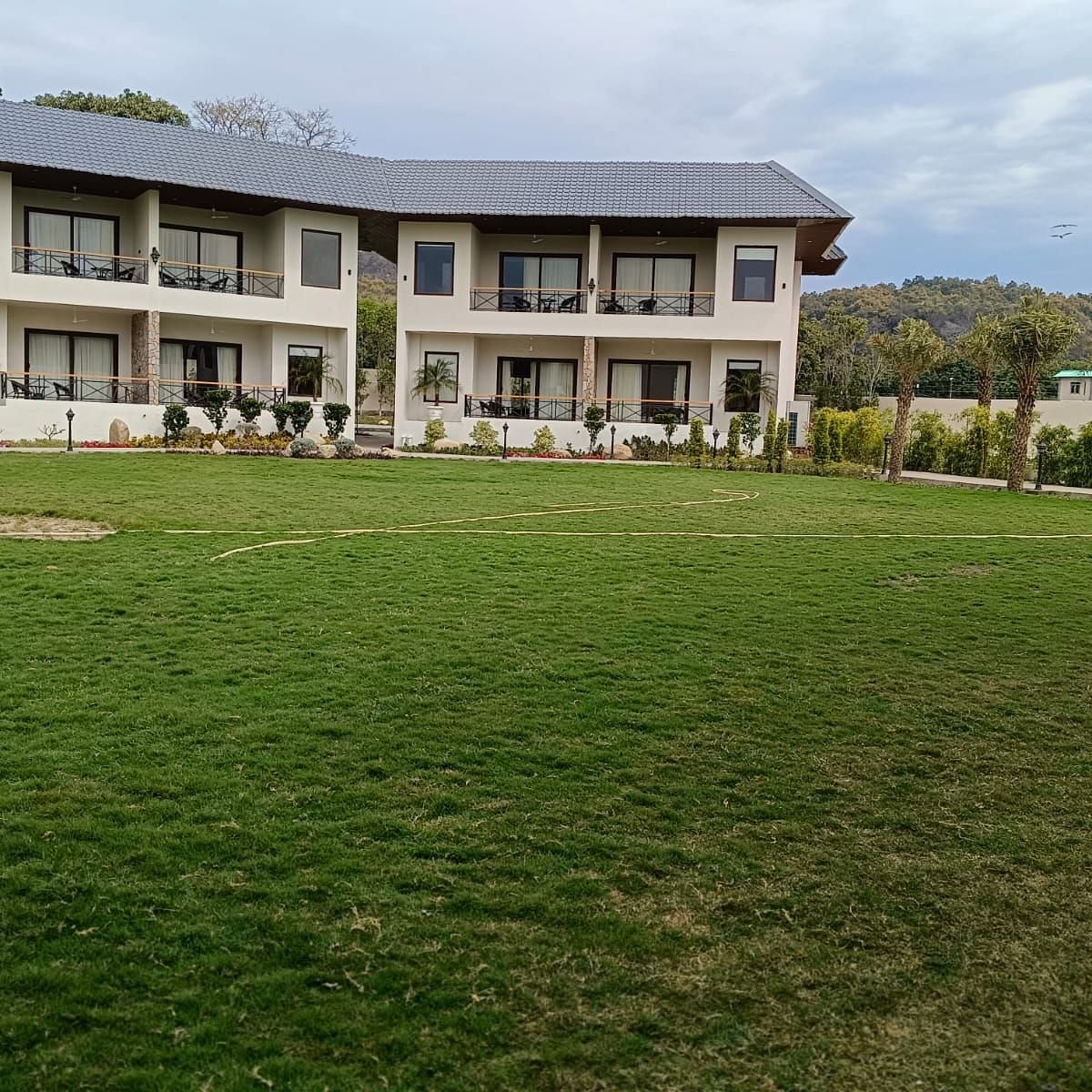Facade view of the building and foliage in front of the property building- Shervani Pebbles & Pines, Corbette