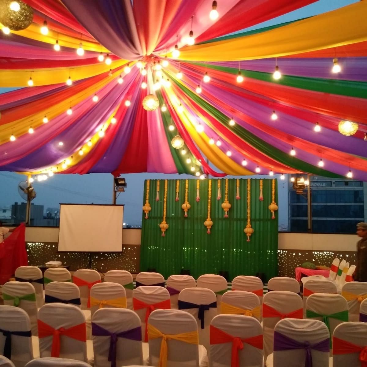 Image of an outdoor event space with chairs and light above at The Oriental Residency