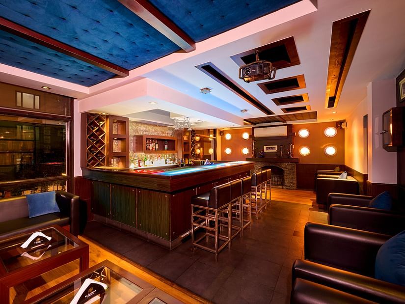 Renest Hotel Manali - Interior view of the bar featuring numerous seating options